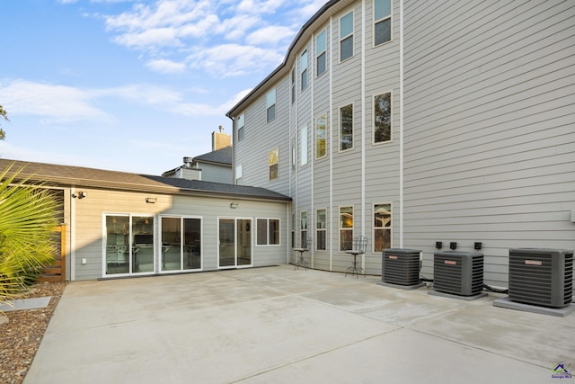 rear view of property featuring a patio and central AC unit