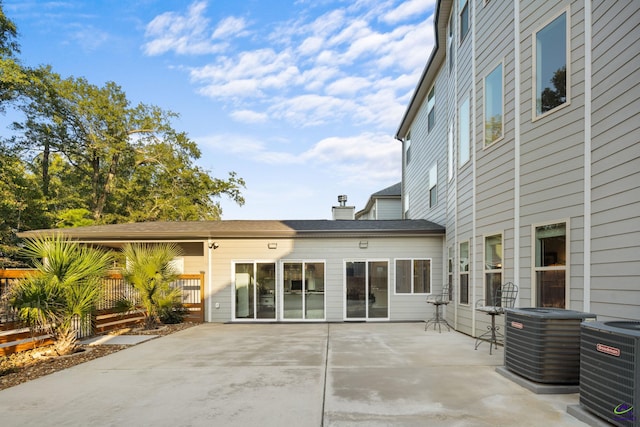 back of property featuring central AC and a patio area