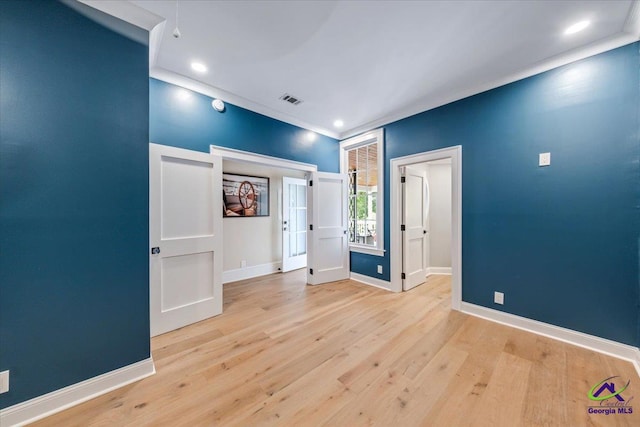 empty room with light hardwood / wood-style flooring