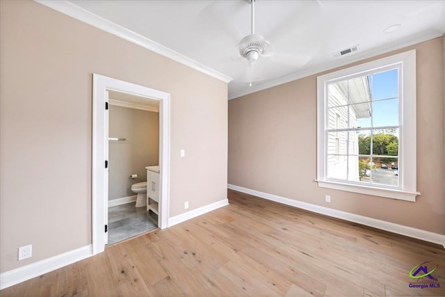 unfurnished bedroom featuring ornamental molding, ceiling fan, ensuite bath, and light hardwood / wood-style floors