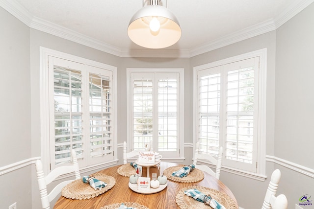 dining room with crown molding and a healthy amount of sunlight