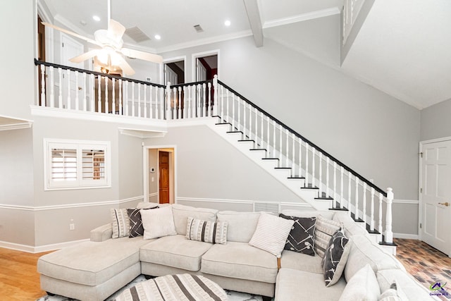 living room featuring ceiling fan, ornamental molding, beam ceiling, high vaulted ceiling, and hardwood / wood-style floors