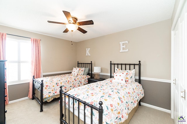 bedroom featuring light colored carpet and ceiling fan