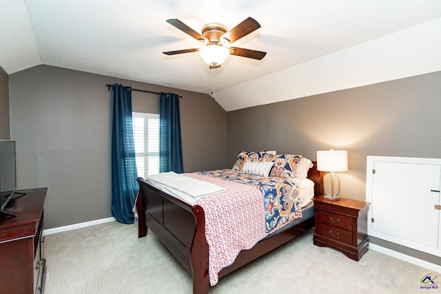 bedroom with light carpet, ceiling fan, and vaulted ceiling