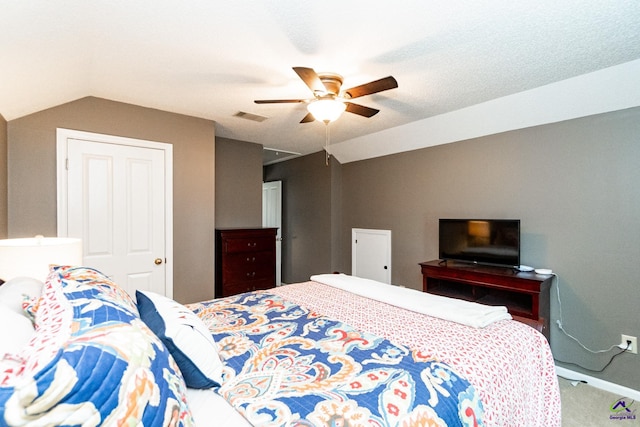 bedroom featuring ceiling fan, vaulted ceiling, and carpet flooring