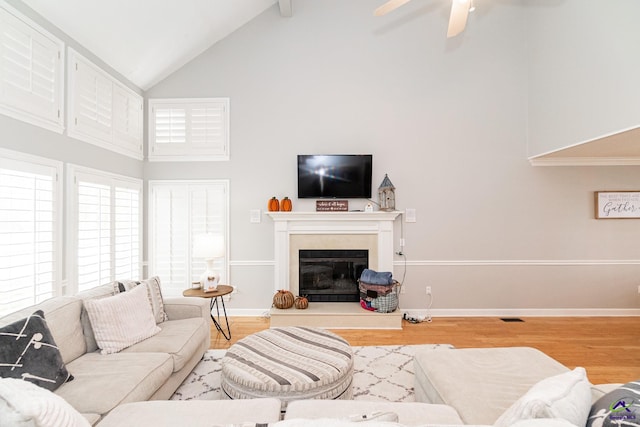 living room with high vaulted ceiling, hardwood / wood-style floors, and ceiling fan