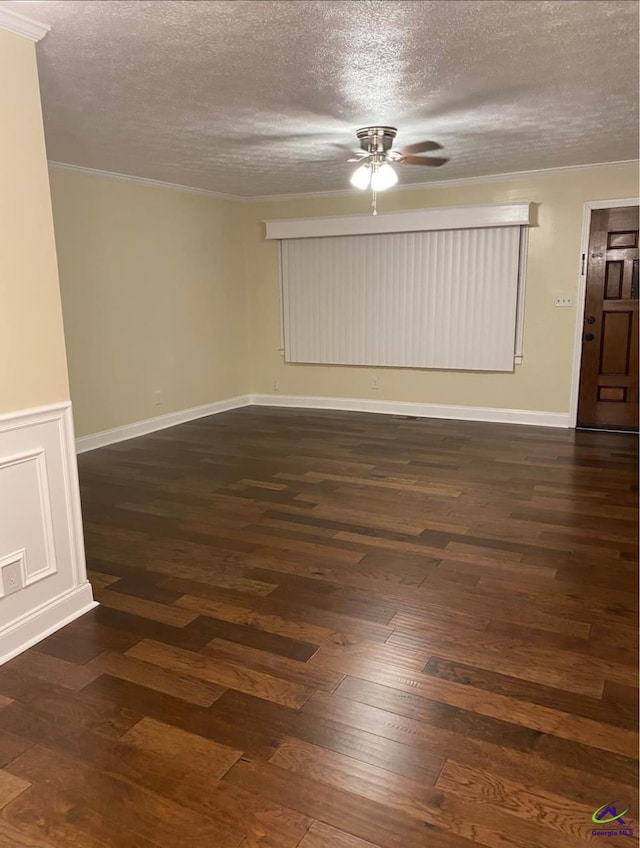 spare room with dark wood-type flooring and a textured ceiling