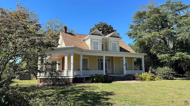 view of front of home featuring a front yard and a porch