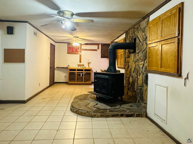 tiled living room featuring crown molding and a wood stove