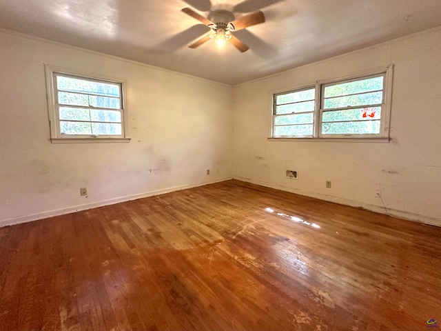 spare room featuring wood-type flooring, plenty of natural light, and ceiling fan