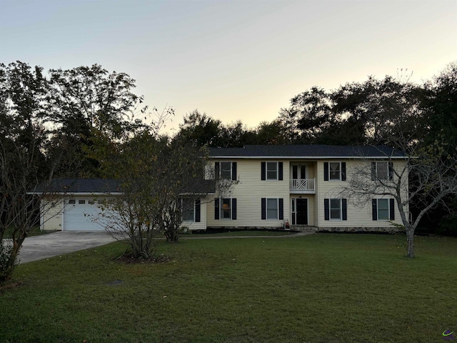 colonial house featuring a balcony and a yard