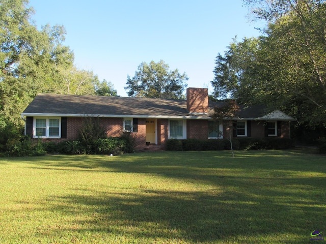 ranch-style home with a front lawn