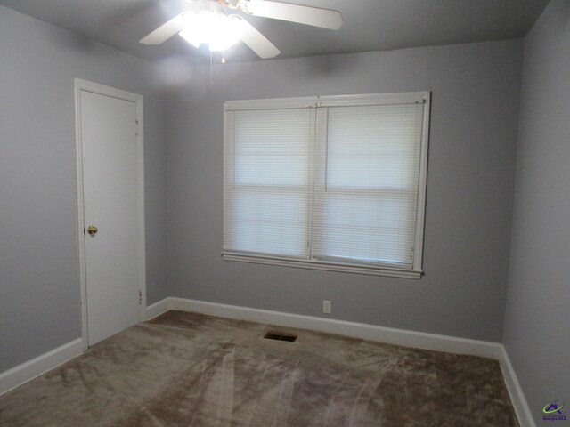 empty room featuring carpet flooring and ceiling fan