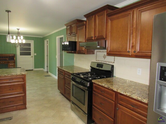 kitchen with decorative backsplash, appliances with stainless steel finishes, light stone countertops, pendant lighting, and a notable chandelier