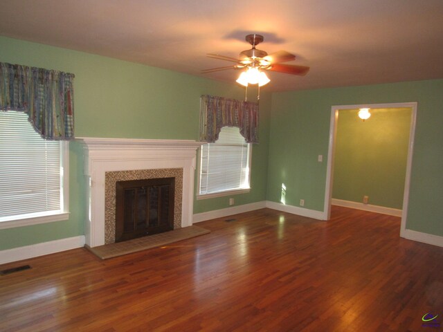 unfurnished living room featuring dark hardwood / wood-style floors and ceiling fan