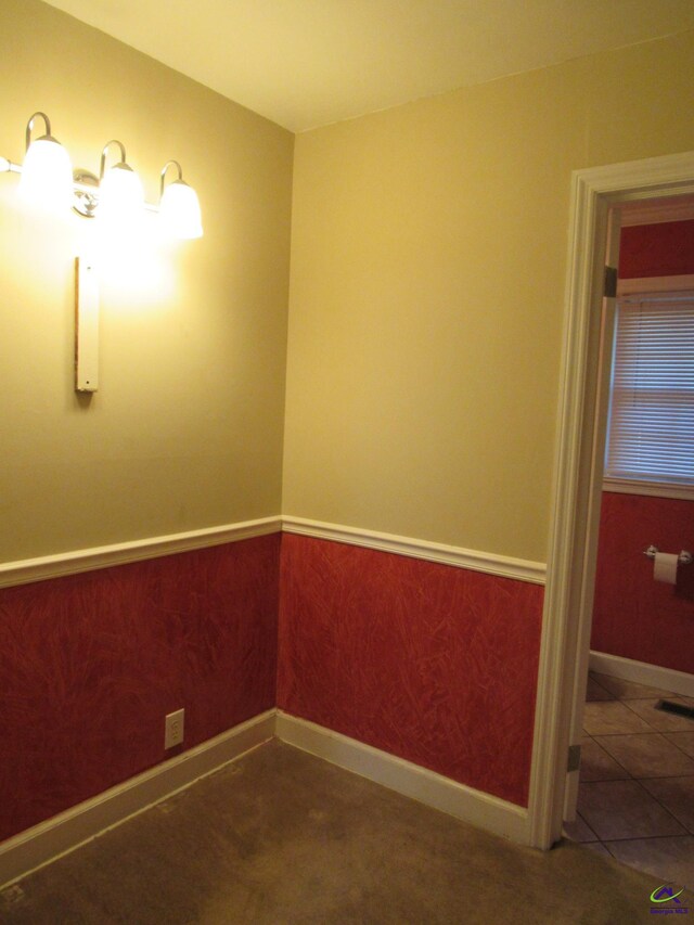 unfurnished room featuring dark colored carpet