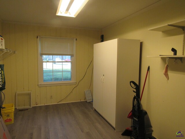 miscellaneous room featuring wooden walls and hardwood / wood-style flooring