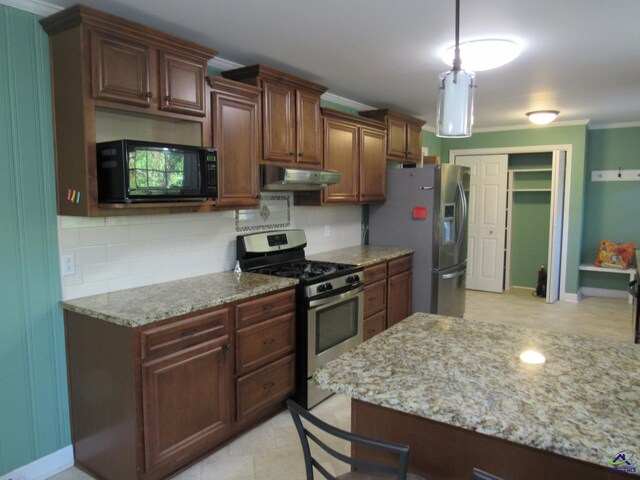 kitchen with appliances with stainless steel finishes, decorative backsplash, ornamental molding, and hanging light fixtures