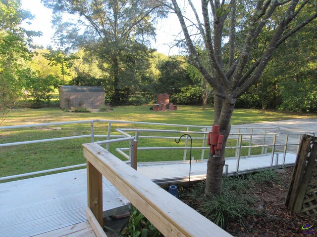 dock area with a wooden deck and a lawn