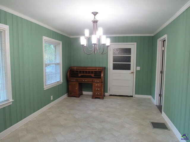 dining room with a notable chandelier and crown molding