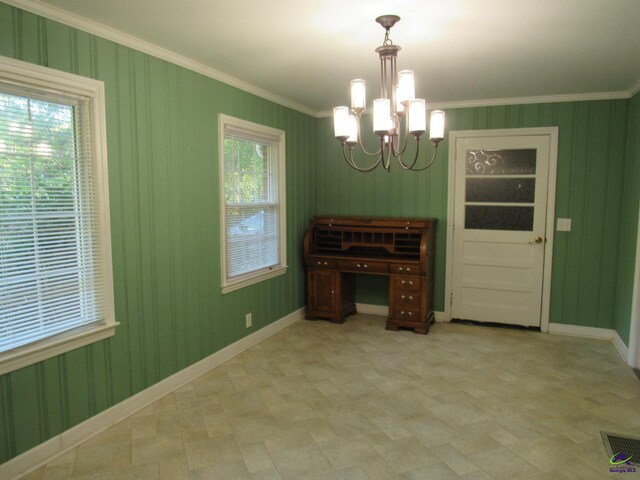 dining area featuring plenty of natural light, ornamental molding, and a chandelier