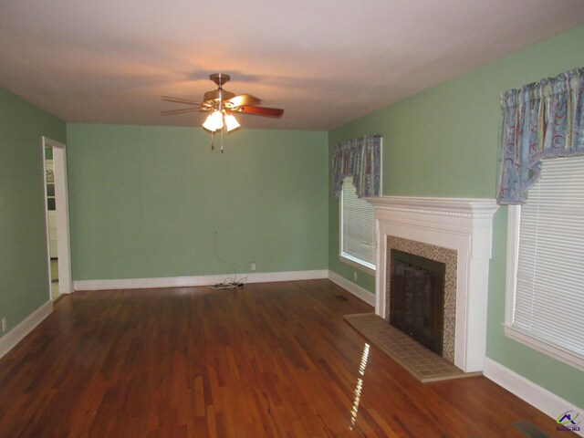 unfurnished living room with ceiling fan and dark hardwood / wood-style floors