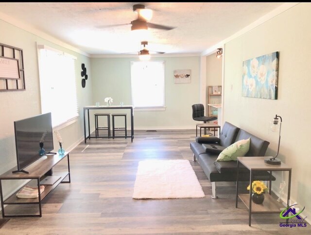 5415 Beulah Ave, Eastman, GA 31023 - living room featuring ceiling fan, ornamental molding, wood finished floors, and baseboards