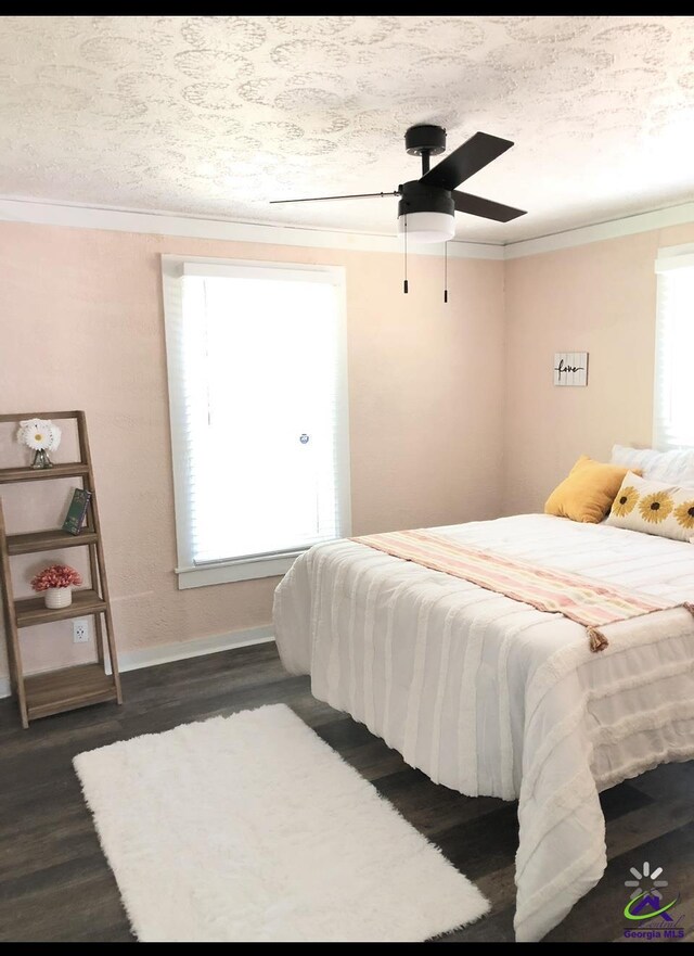 5415 Beulah Ave, Eastman, GA 31023 - bedroom featuring crown molding, dark wood-style floors, baseboards, and ceiling fan