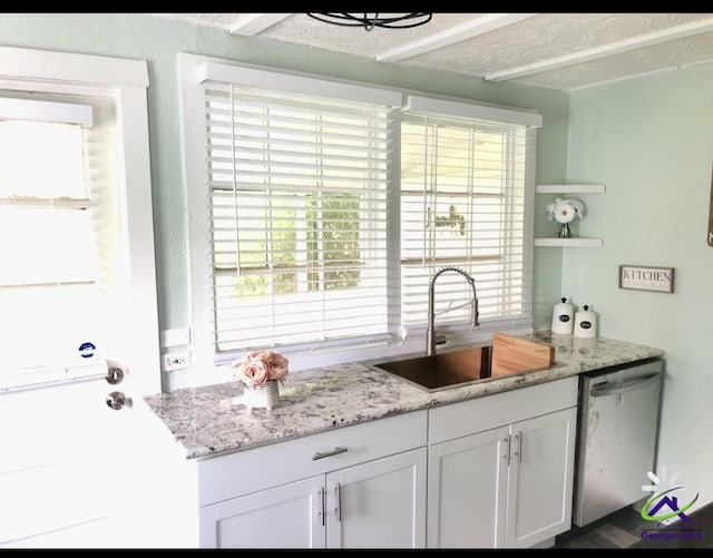 5415 Beulah Ave, Eastman, GA 31023 - kitchen with a sink, stainless steel dishwasher, white cabinets, open shelves, and light stone counters