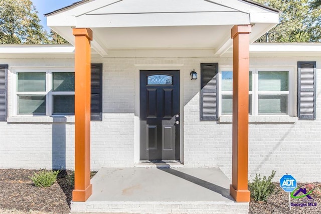 doorway to property featuring covered porch