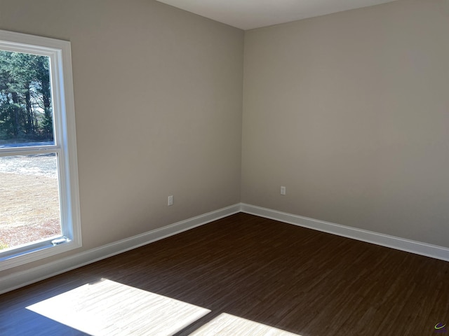 empty room with dark hardwood / wood-style floors