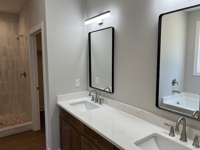 bathroom featuring shower with separate bathtub, wood-type flooring, and vanity