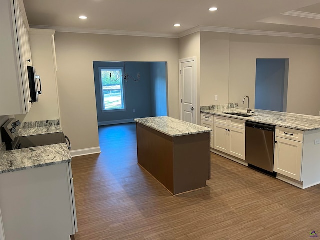 kitchen with white cabinets, sink, hardwood / wood-style flooring, a kitchen island, and stainless steel appliances