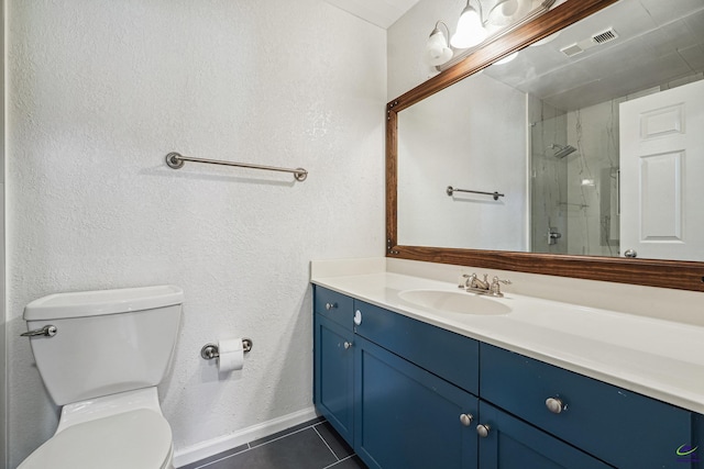 bathroom with vanity, toilet, tile patterned floors, and a shower with door