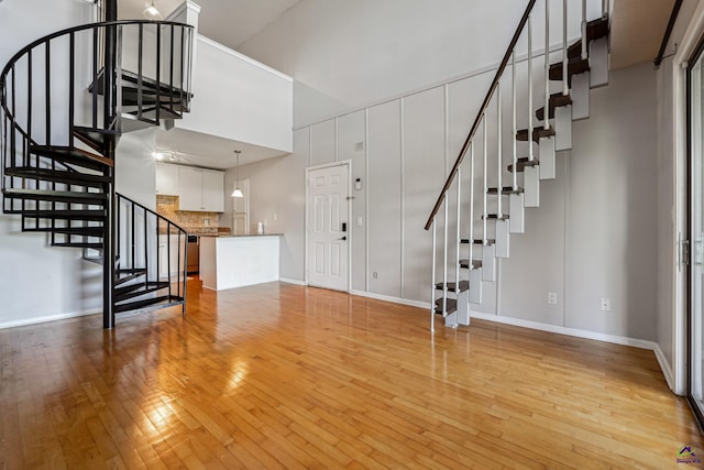 interior space featuring a high ceiling and hardwood / wood-style floors