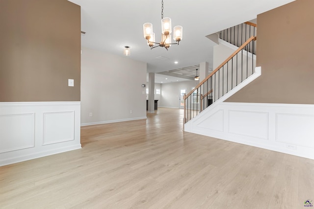 interior space featuring light wood-style flooring, stairs, a chandelier, and recessed lighting