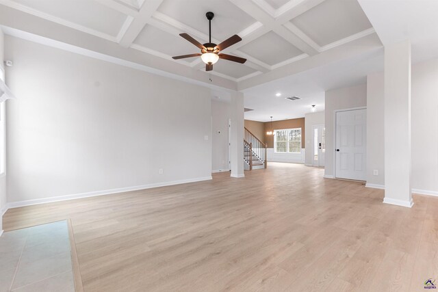 unfurnished living room with visible vents, coffered ceiling, baseboards, stairway, and light wood-style floors