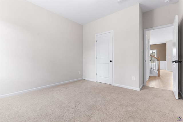 unfurnished bedroom featuring carpet and baseboards