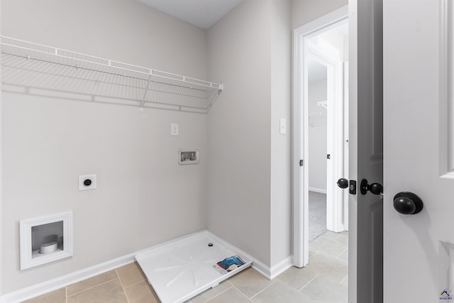 laundry room featuring light tile patterned floors, hookup for a washing machine, hookup for an electric dryer, laundry area, and baseboards