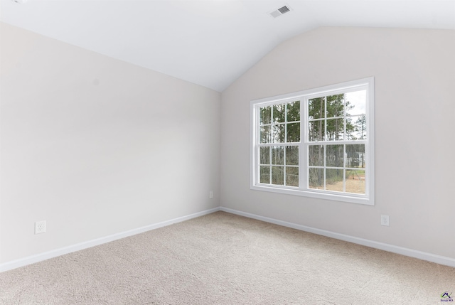 unfurnished room featuring light colored carpet, visible vents, and a healthy amount of sunlight