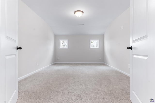 carpeted empty room featuring visible vents and baseboards