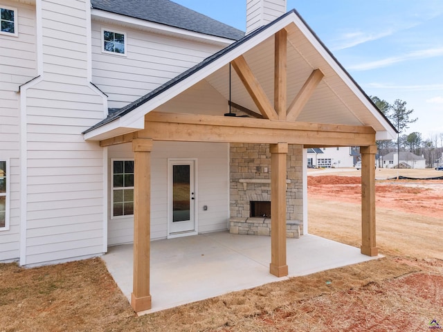 view of patio / terrace featuring an outdoor stone fireplace