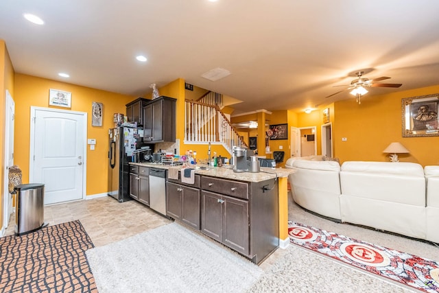 kitchen featuring ceiling fan, dark brown cabinets, stainless steel dishwasher, and black refrigerator