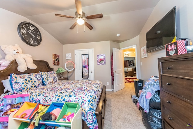 bedroom featuring light carpet, lofted ceiling, a closet, and ceiling fan