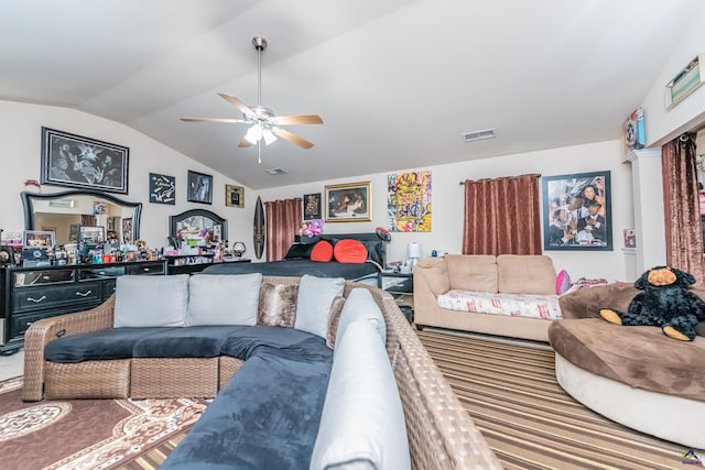 living room featuring ceiling fan and lofted ceiling