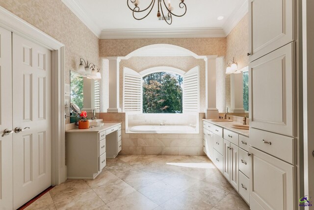 bathroom featuring vanity, crown molding, ornate columns, and tiled tub