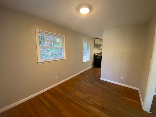 unfurnished room featuring dark wood-type flooring