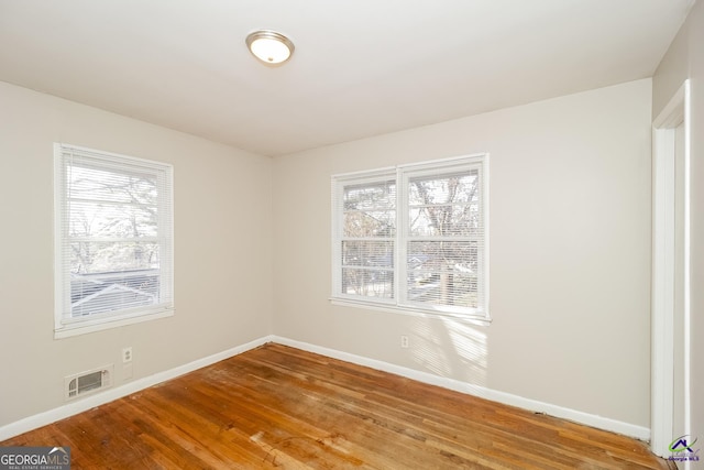 spare room featuring hardwood / wood-style floors