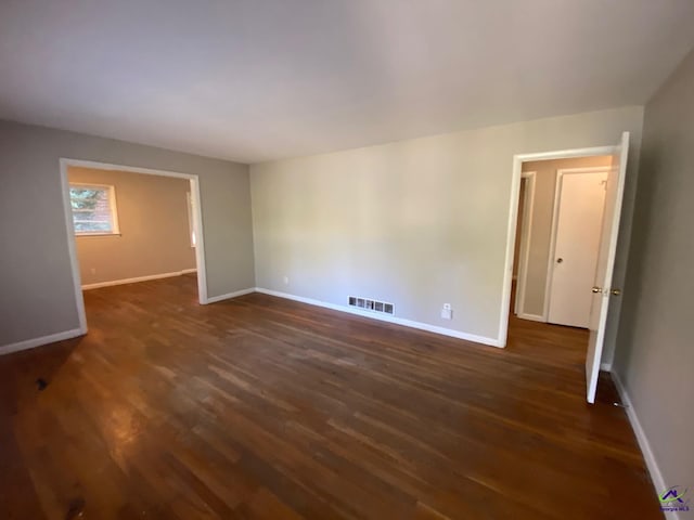 unfurnished room featuring dark hardwood / wood-style flooring