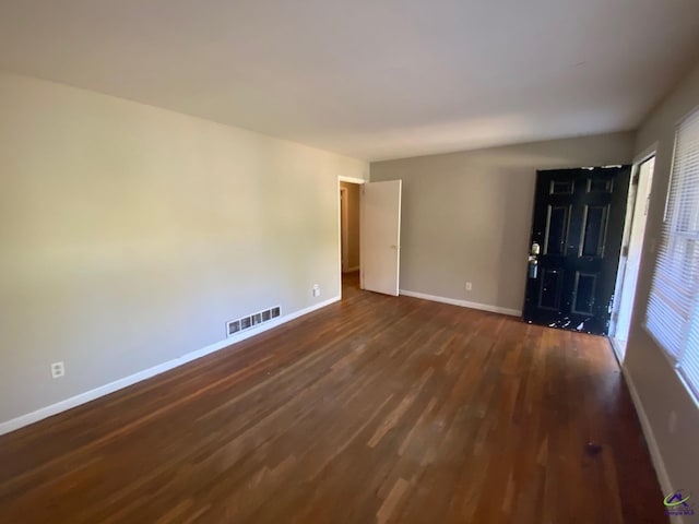 empty room with dark wood-type flooring